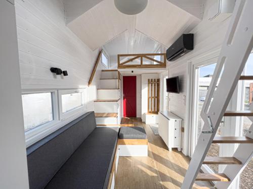 a tiny house with a staircase and a couch at Red Tiny House in Sopot