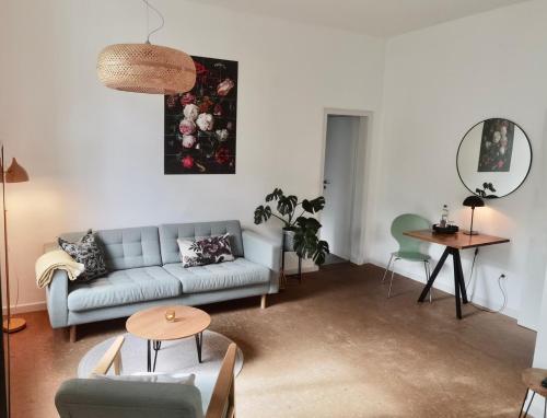 a living room with a couch and a table at Apartments "Am Rheinorange", Netflix, Amazon Prime in Duisburg