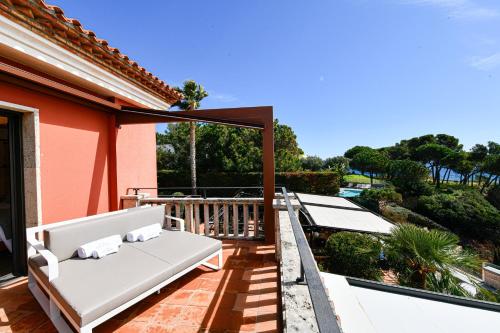 a white couch on the balcony of a house at Hotel Cala del Pi - Adults Only in Platja  d'Aro