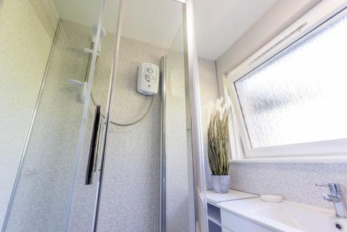 ein Bad mit einer Dusche und einem Waschbecken in der Unterkunft Stunning City Centre 1 Bed with Free Parking in Glasgow