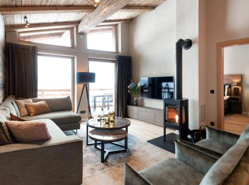 a living room with a couch and a fireplace at Residenz Illyrica Tirol in Westendorf