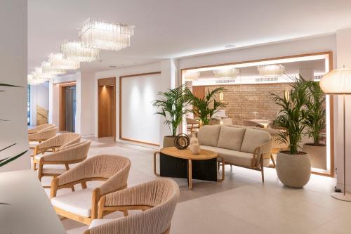 a waiting room with chairs and a couch at Hotel Cala del Pi - Adults Only in Platja  d'Aro