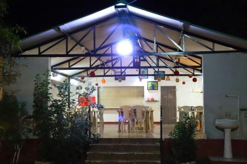 a room with chairs and a light on a building at Danak Farm And Resort in Sasan Gir