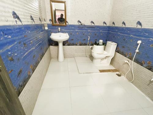 a bathroom with a toilet and a sink at Danak Farm And Resort in Sasan Gir