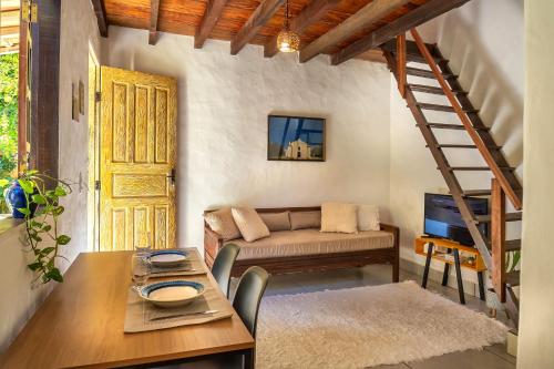 a living room with a couch and a table at Bangalô Arco Íris (Quadrado Trancoso) in Trancoso