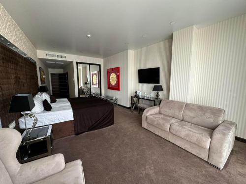 a hotel room with a bed and a couch at Maristella Marine Residence in Odesa