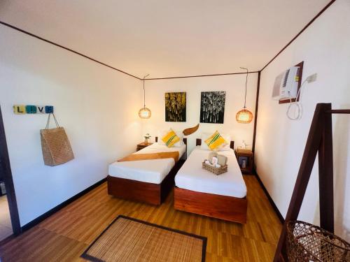 a room with two beds in a room at Bella Athena Garden in El Nido