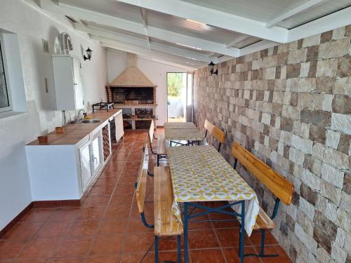 a room with a table and benches in a kitchen at Villa Familia Dehoux in Camacha