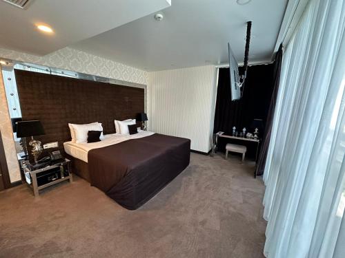 a bedroom with a large bed in a room at Maristella Marine Residence in Odesa
