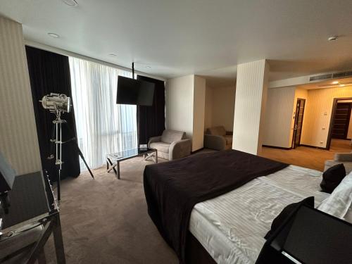 a hotel room with a bed and a camera at Maristella Marine Residence in Odesa