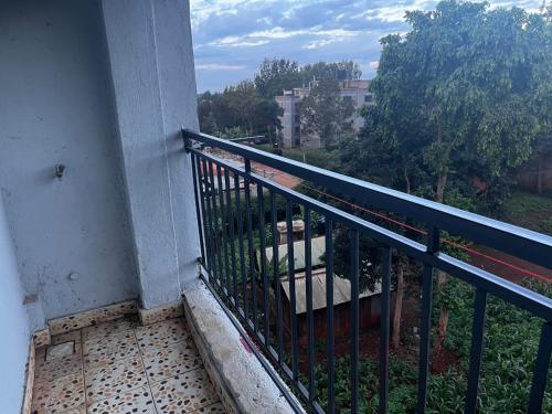 a balcony with a black railing and a tree at Klimax Homes in Kiambu