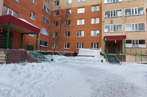 a building with a pile of snow in front of it at Аэропорт Астана 5 минут юг1 233 in Prigorodnyy