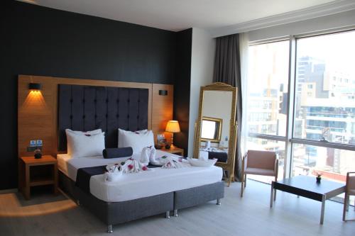 a hotel room with two beds and a mirror at Vplus hotel atasehir in Istanbul