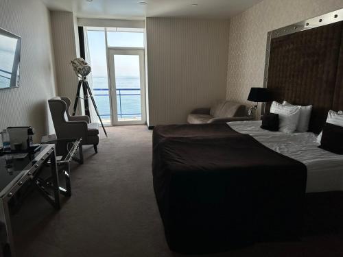 a hotel room with a bed and a camera at Maristella Marine Residence in Odesa