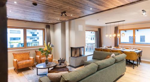 a living room with a couch and a fireplace at Residenz Illyrica Tirol in Westendorf