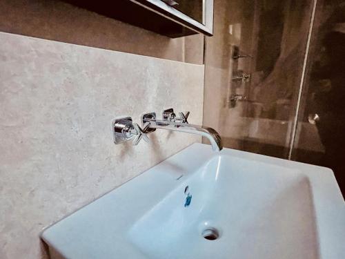 a bathroom sink with a faucet on the wall at Exklusive Wohnung im Herzen von Göppingen in Göppingen