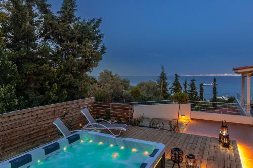 a backyard with a hot tub on a deck at Albore ImBlue, Jacuzzi Bliss in Countryside Escapes in Palaiokastro