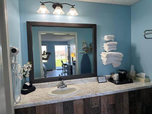 a bathroom with a sink and a mirror at Geneva Wells Inn in Lake Geneva