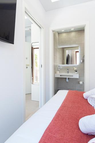 a bedroom with a white bed with a red rug at Myflats Luxury Cathedral in Alicante
