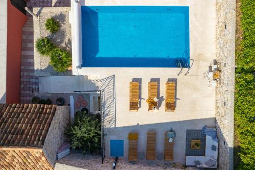 an overhead view of a swimming pool next to a house at Cavtat Old School in Cavtat