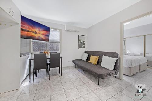 a living room with a table and a couch and a bed at Fairfield 1B Granny Flat Sleep up to 4 ppl in Fairfield