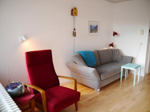 a living room with a couch and a chair at Ferienwohnung Auch am Berg, Todtnauberg, Feldberg in Ennerbach