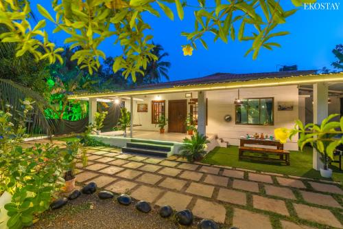 a house with a stone patio in front of it at EKO STAY- CASA POLO Villa in Alibaug
