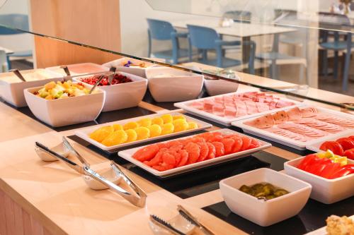 a buffet of different types of food on a table at H+ Hotel 4Youth in Berlin