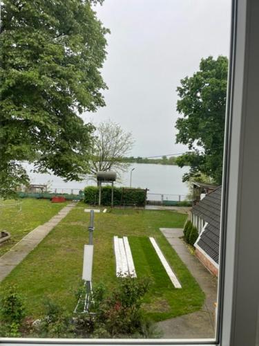 a view from a window of a park with a bench at Retro Motel Mályi in Mályi