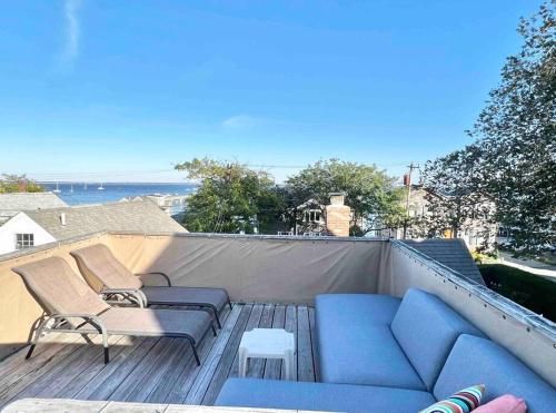 a blue couch and chairs sitting on a roof at Luxury Water-View West End Condo in Provincetown