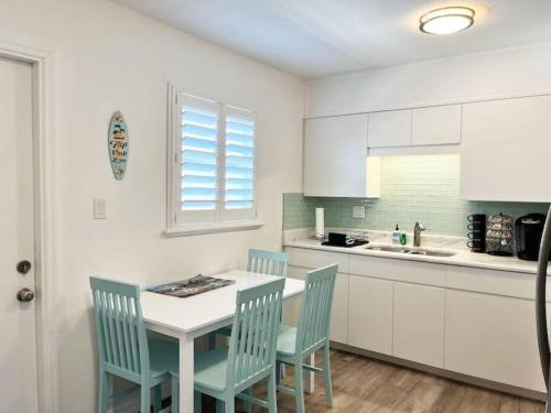 a kitchen with a table and chairs and a sink at Modern Apartment - 3 of 4 in Punta Gorda
