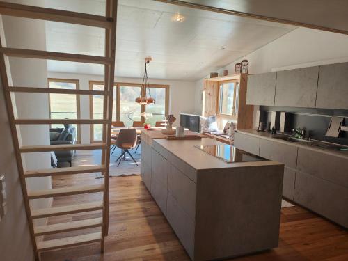 a kitchen with a staircase leading to a living room at Thomas's Loft in Stühlingen