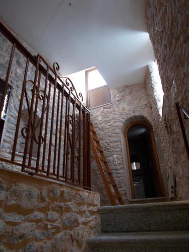 a staircase in a stone building with a stair railing at Traditional Guest house Chrisyis in Pyrgi