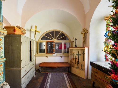 a room with a bed and a cabinet and a christmas tree at Zamek Międzylesie in Międzylesie