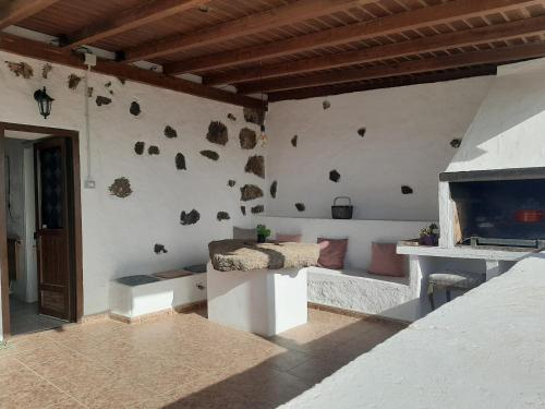 a room with a wall with rocks on it at Sunset Terrace in La Oliva