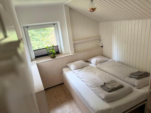 a bed in a room with a window at Chalet Franzi in Dorfgastein