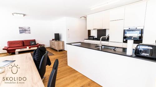 a kitchen and living room with a table and chairs at Haus Golmenegg, Riederalp in Riederalp