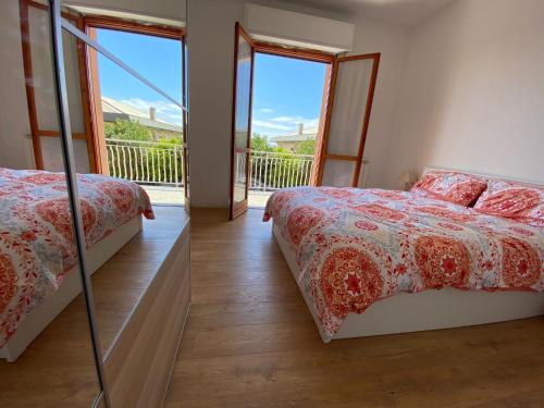 Cet appartement comprend une chambre avec deux lits et un balcon. dans l'établissement Moderna Casa Fronte Mare, à Cogoleto