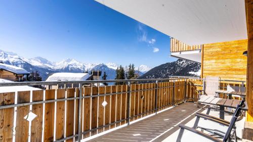a balcony with chairs and a view of mountains at Haus Golmenegg, Riederalp in Riederalp