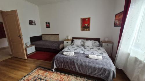 1 dormitorio pequeño con 1 cama y 1 sofá en Dunakeszi Nap Apartman, en Dunakeszi