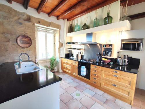 a kitchen with a sink and a stove top oven at La Terrasse du Pont du Gard in Saint-Bonnet-du-Gard