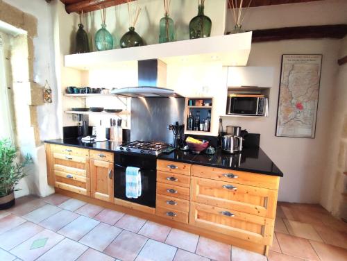 a kitchen with a stove and a counter top at La Terrasse du Pont du Gard in Saint-Bonnet-du-Gard