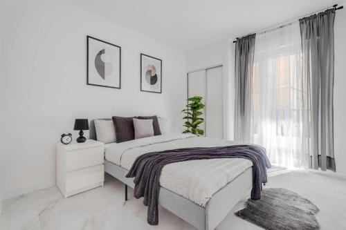 - une chambre blanche avec un lit et une fenêtre dans l'établissement Princesa Blanka by ZANIS, à Torrevieja