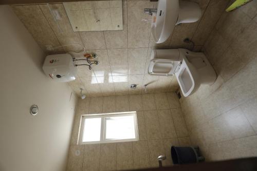 an overhead view of a bathroom with two toilets and a window at The Grand View Studio in Vrindāvan