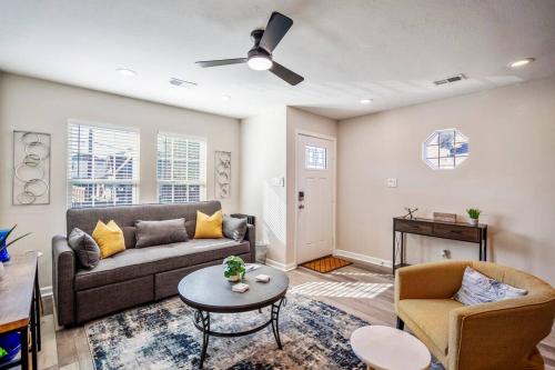 a living room with a couch and a table at Winter Retreat 3b 3ba Huge backyard Mins from Downtown in Houston