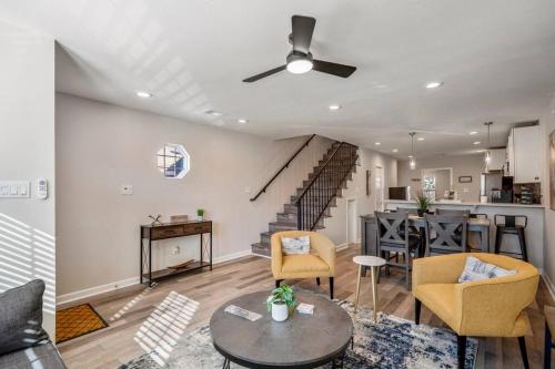 a living room with a table and chairs and a staircase at Winter Retreat 3b 3ba Huge backyard Mins from Downtown in Houston