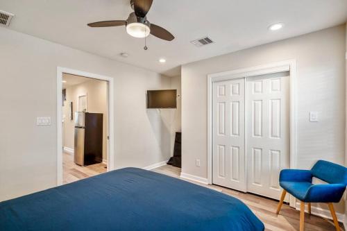 a bedroom with a blue bed and a blue chair at Winter Retreat 3b 3ba Huge backyard Mins from Downtown in Houston