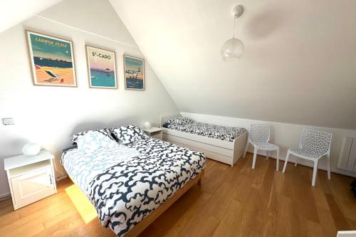 a bedroom with a bed and two chairs in it at Feet in the water breathtaking 180 sea view! in Port-Louis