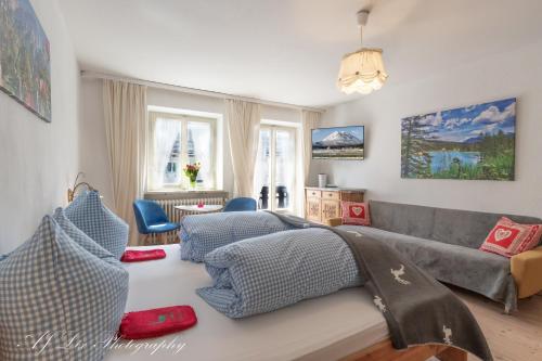 a living room with a couch and a living room with at Pension Karner in Mittenwald