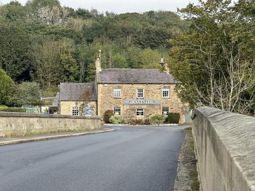 a stone house on the side of a road at The Boatside Inn - Hadrian - Twin Ensuite in Hexham